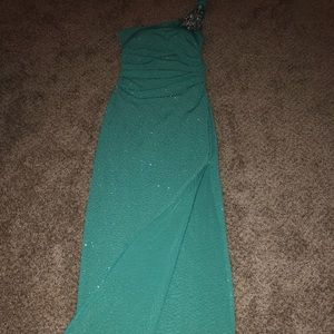 Long off the shoulder green sparkly dress.